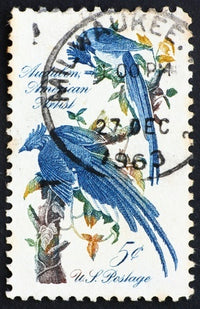 A letter stamp with blue birds on it, postmarked in Milwaukee, Wi on Dec 27, 1963.